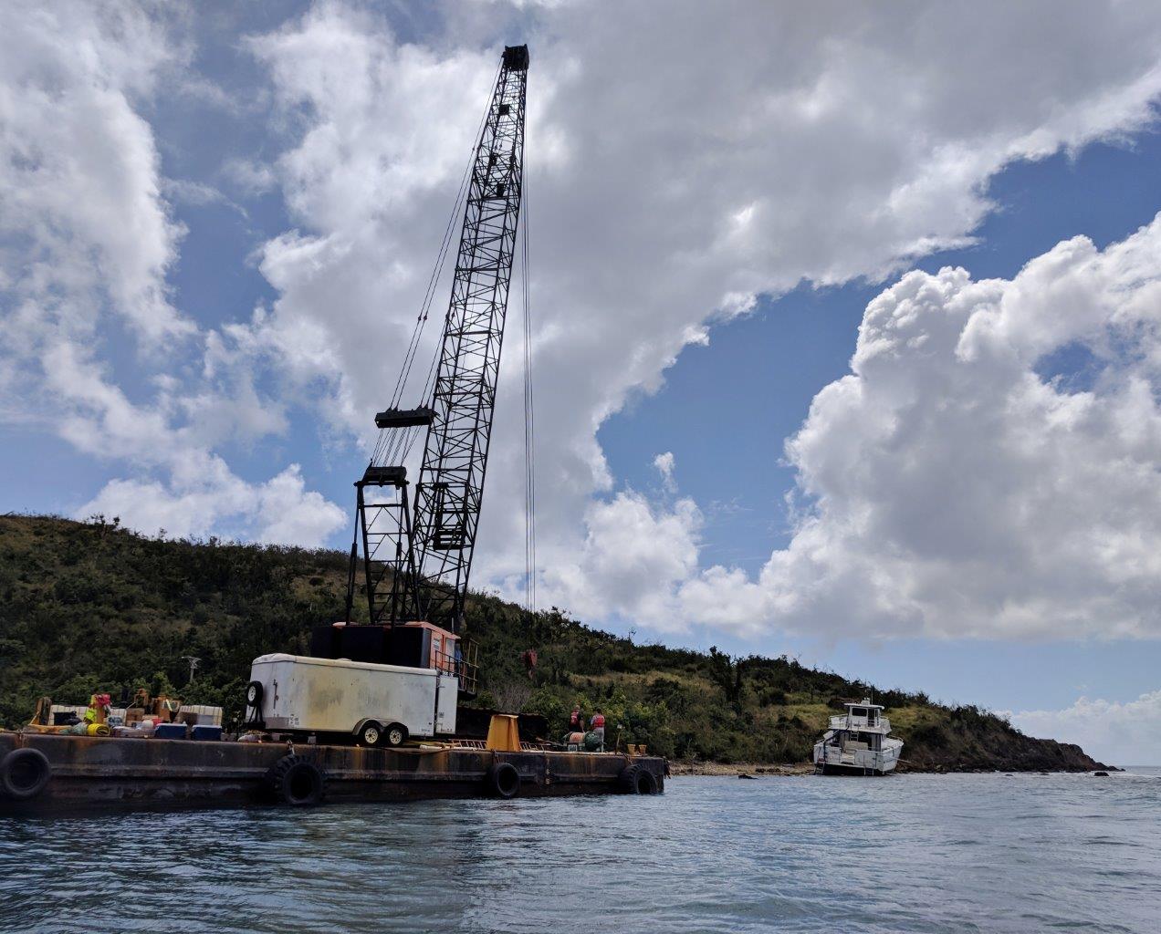 Crane preparing to lift wrecked boat